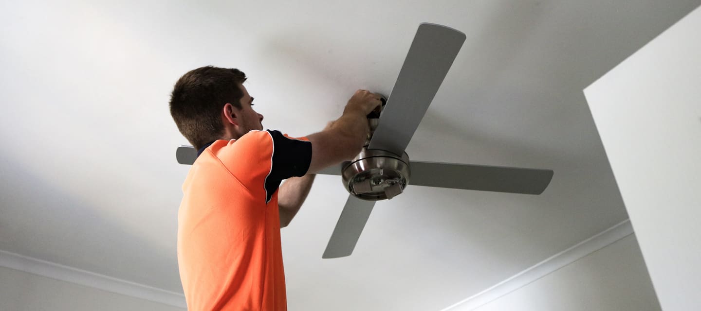 A Lahn Electrics electrician installing a ceiling fan