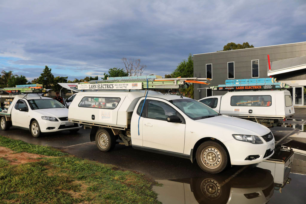 Lahn Electrics utes lined up at the workshop